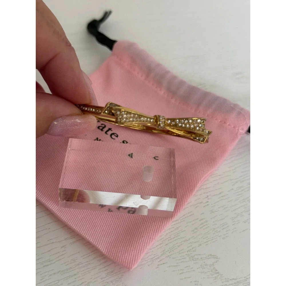 Kate Spade New York Gold Tone Pave Crystal Bow Hinged Bangle Bracelet with Bag
